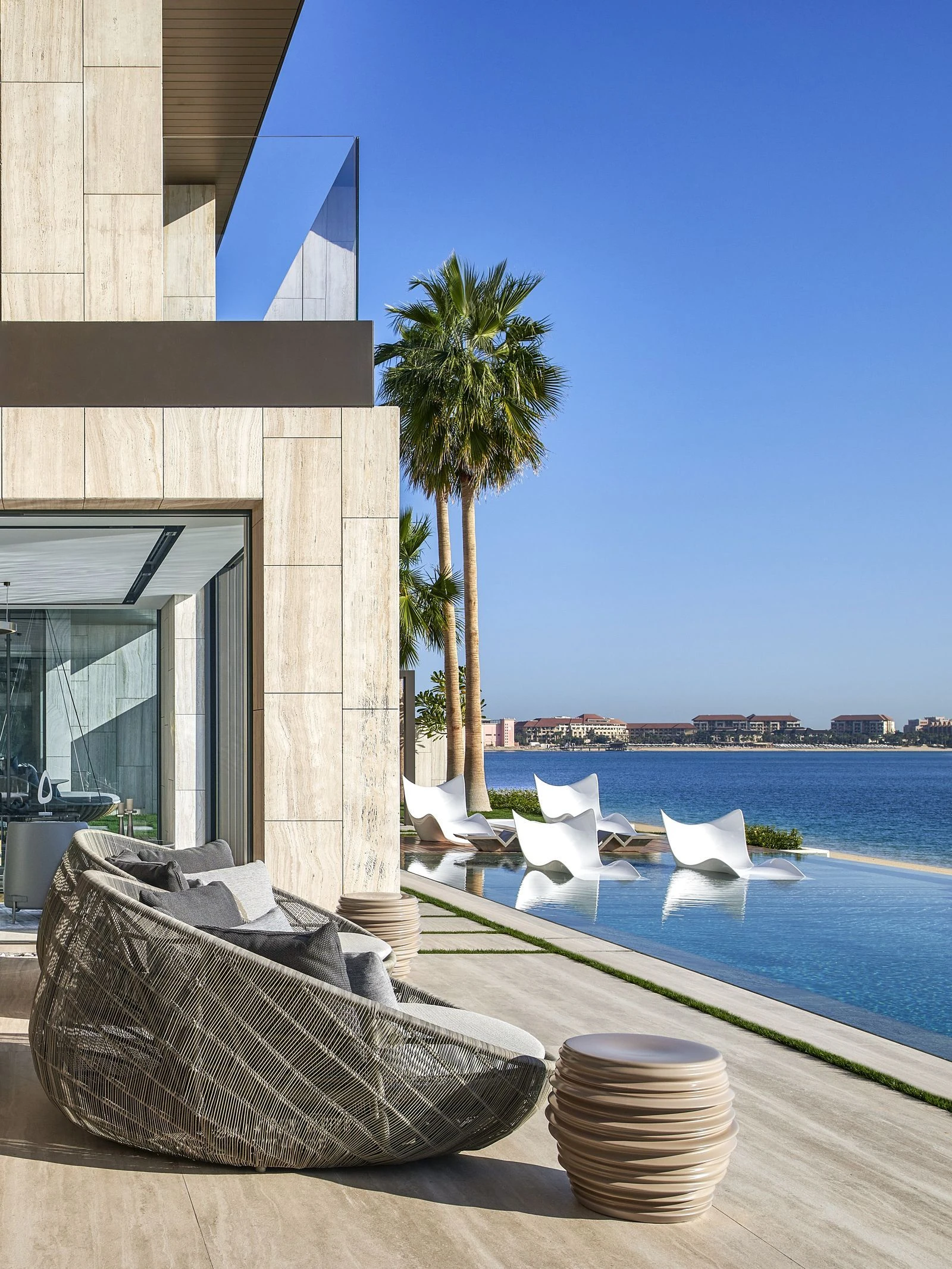 Waterfront pool lounge in natural stone